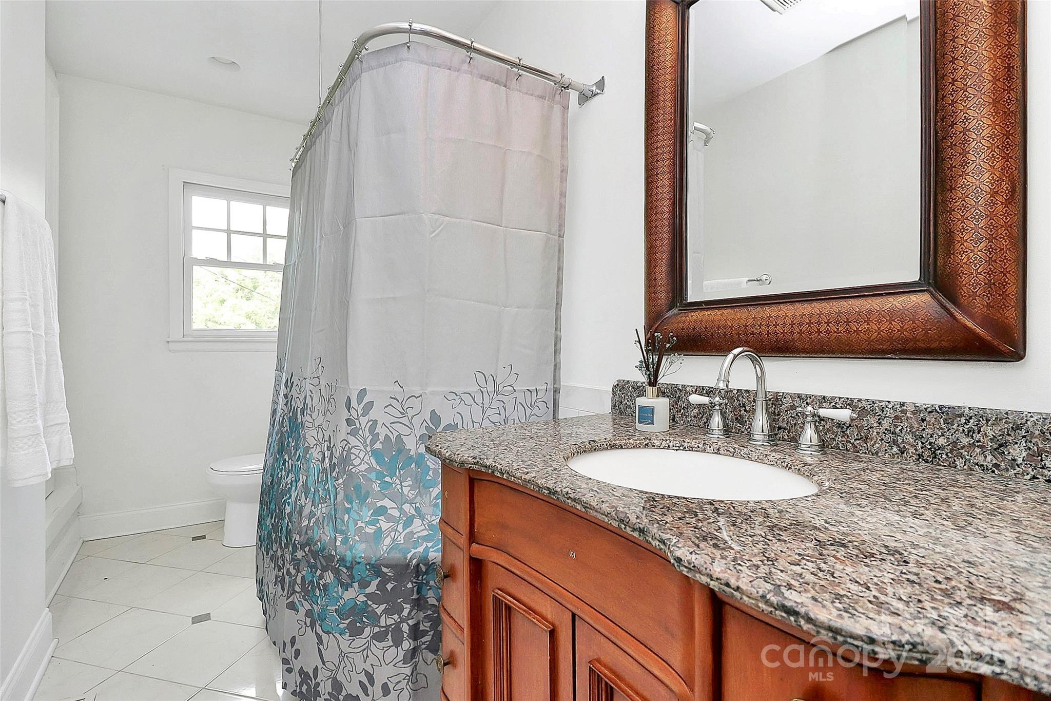 6500 Old Providence Road Charlotte, NC 28226 - Photo 21 of 40 a bathroom with a granite countertop sink and a mirror