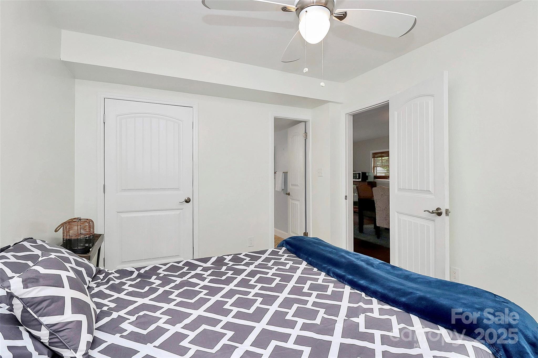 6500 Old Providence Road Charlotte, NC 28226 - Photo 29 of 40 a bedroom with a bed and a chandelier