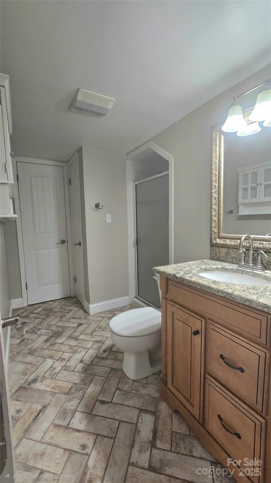 6500 Old Providence Road Charlotte, NC 28226 - Photo 32 of 40 a bathroom with a granite countertop toilet a sink a mirror and vanity