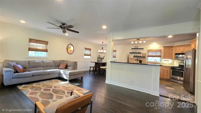 a living room with furniture and kitchen view