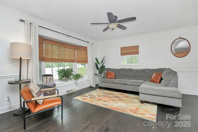 a living room with kitchen island furniture and a wooden floor