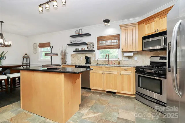a kitchen with stainless steel appliances granite countertop a stove oven and a refrigerator
