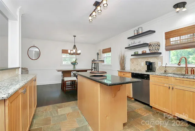 a bedroom with a bed and a flat tv screen on dresser