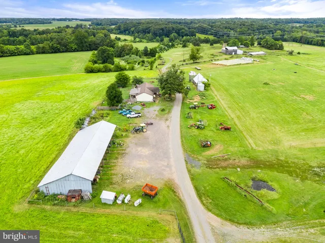 a view of a swimming pool with a patio and a yard