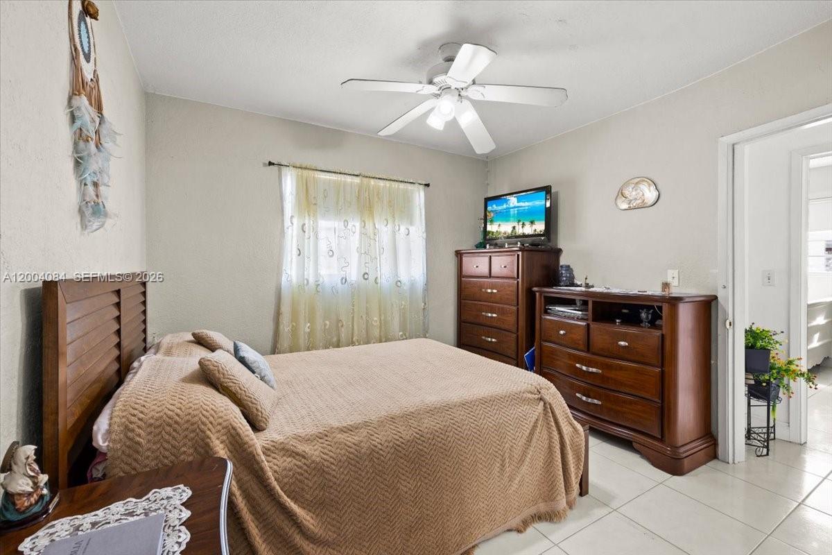 9025 Southwest 36th Street Miami, FL 33165 - Photo 11 of 20 a bedroom with a bed and a television