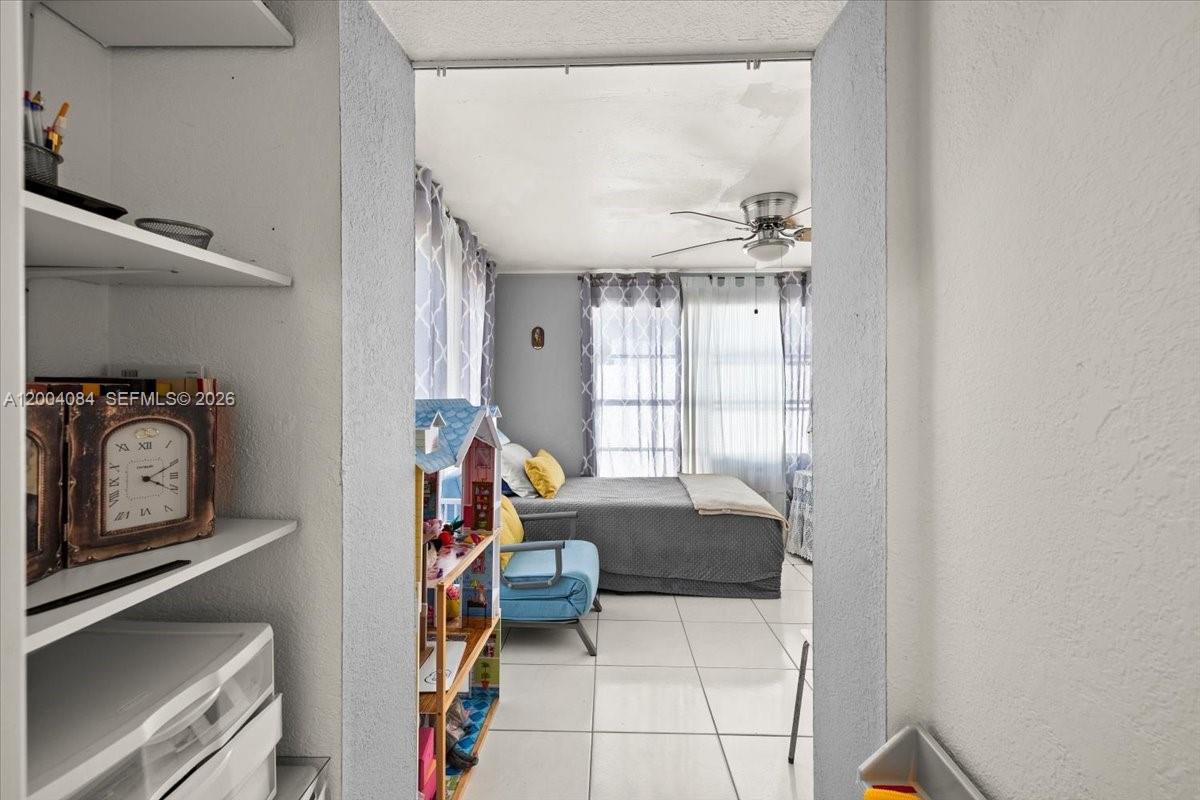 9025 Southwest 36th Street Miami, FL 33165 - Photo 16 of 20 a bedroom with furniture and a window