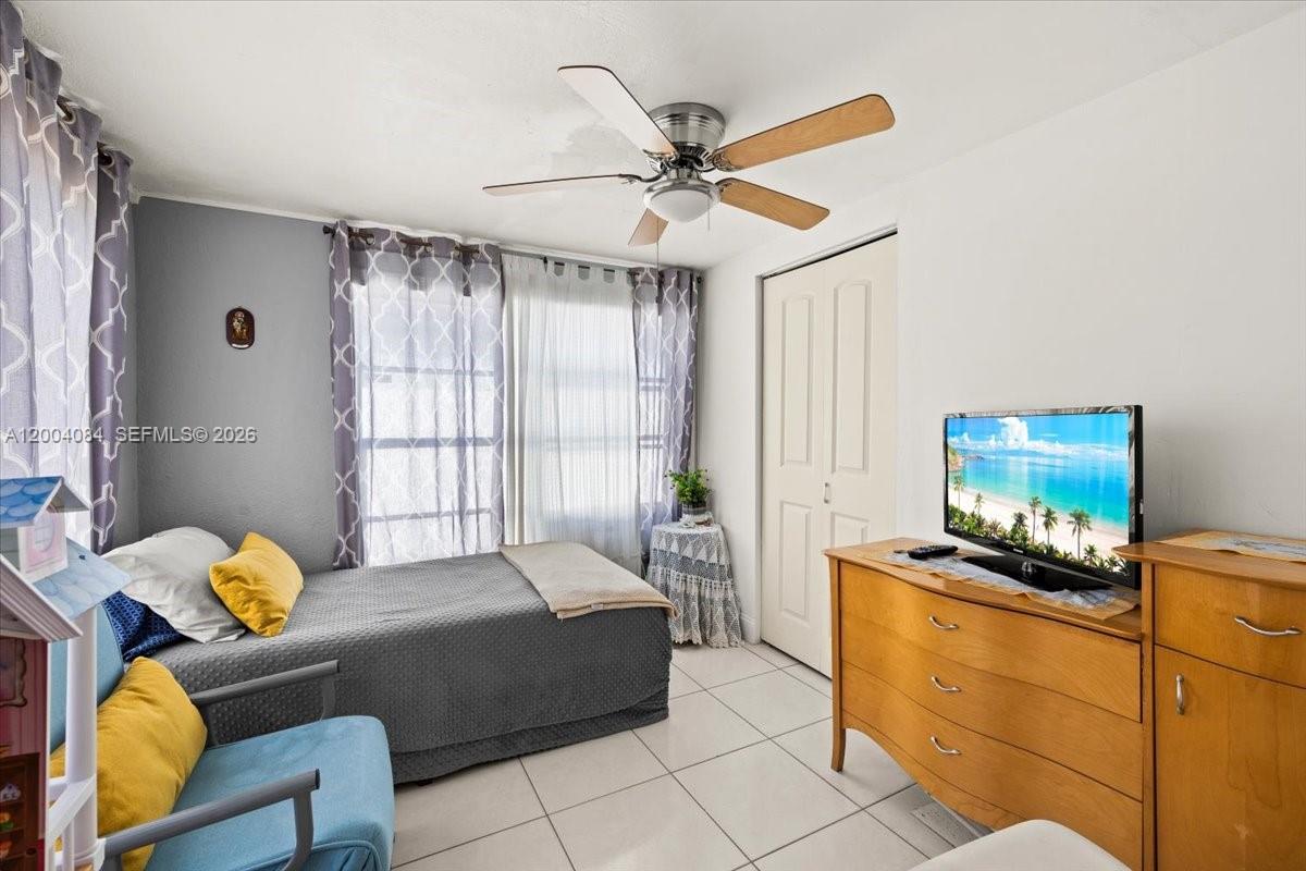 9025 Southwest 36th Street Miami, FL 33165 - Photo 17 of 20 a bedroom with furniture and a window
