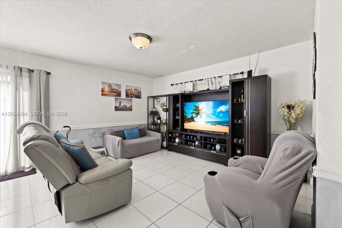 9025 Southwest 36th Street Miami, FL 33165 - Photo 5 of 20 a living room with furniture and a flat screen tv