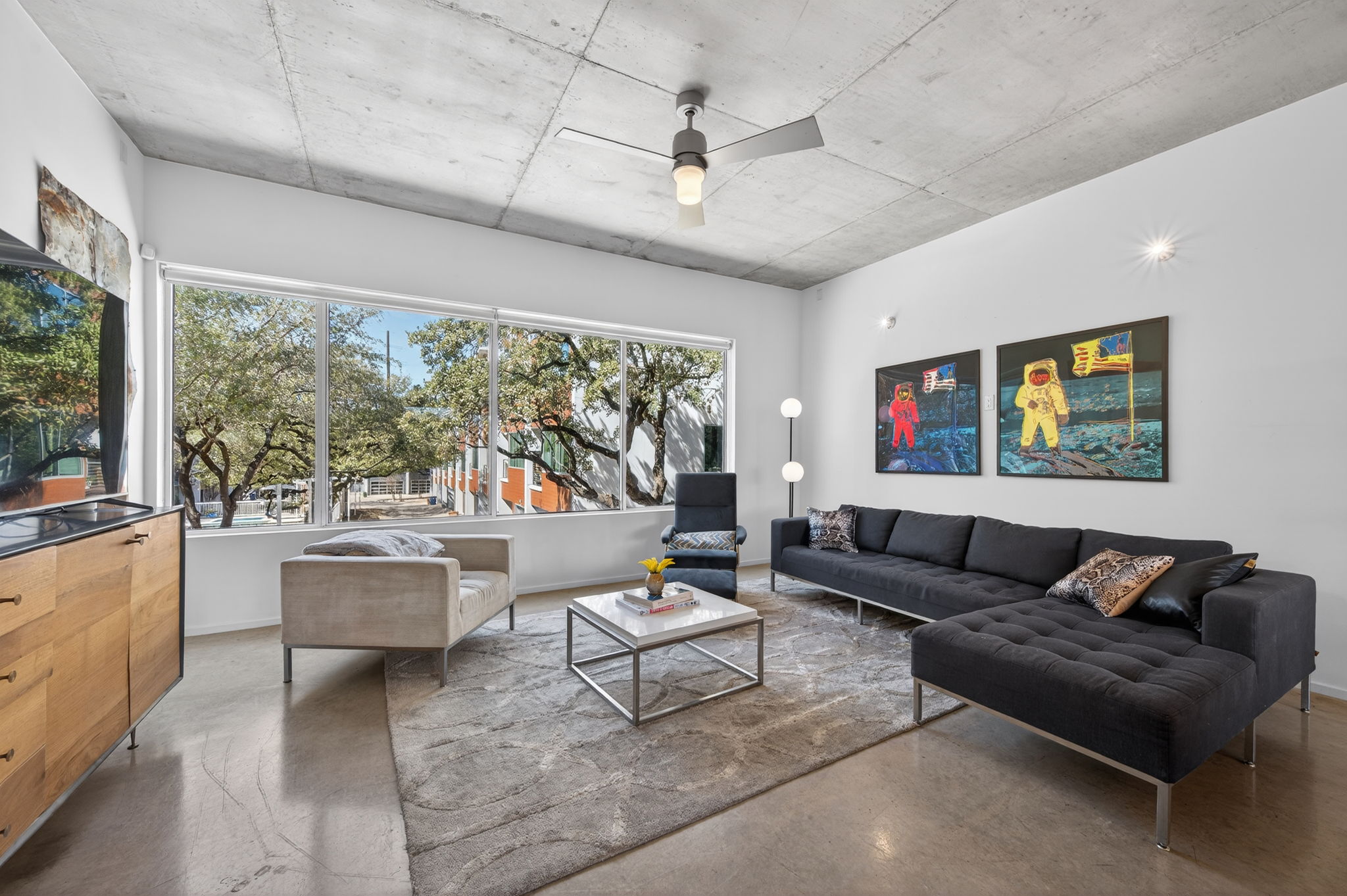 2301 South 5th Street, Unit 25 Austin, TX 78704 - Photo 2 of 35 Living area with finished concrete floors and ceiling fan