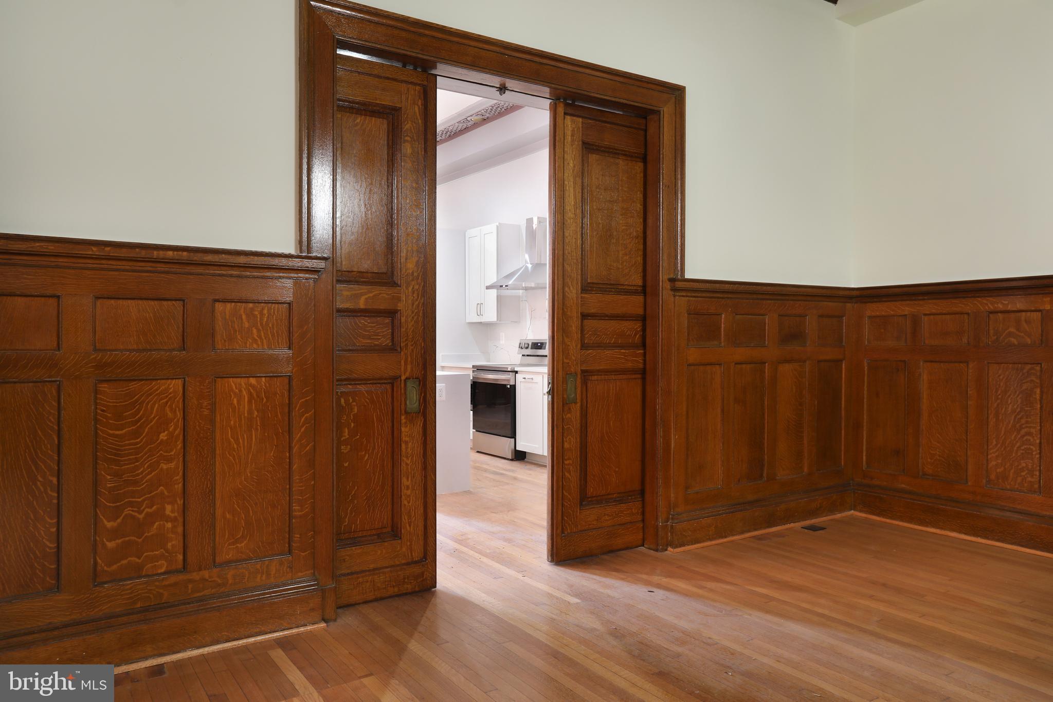 812 Park Avenue, Unit 2FR Baltimore, MD 21201 - Photo 11 of 30 an empty room with wooden floor and windows