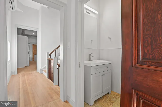 a kitchen with stainless steel appliances a refrigerator and white cabinets