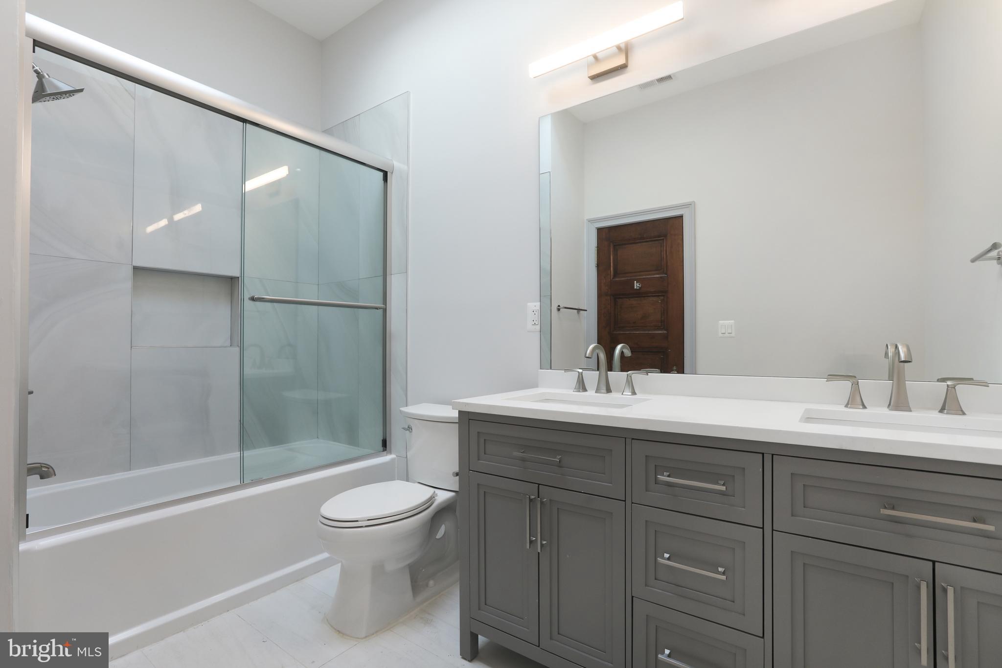 812 Park Avenue, Unit 2FR Baltimore, MD 21201 - Photo 24 of 30 a bathroom with a granite countertop sink toilet and shower