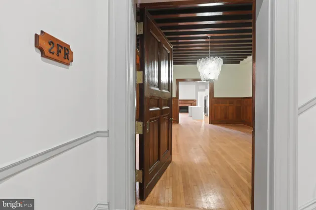 a view of hallway with wooden floor