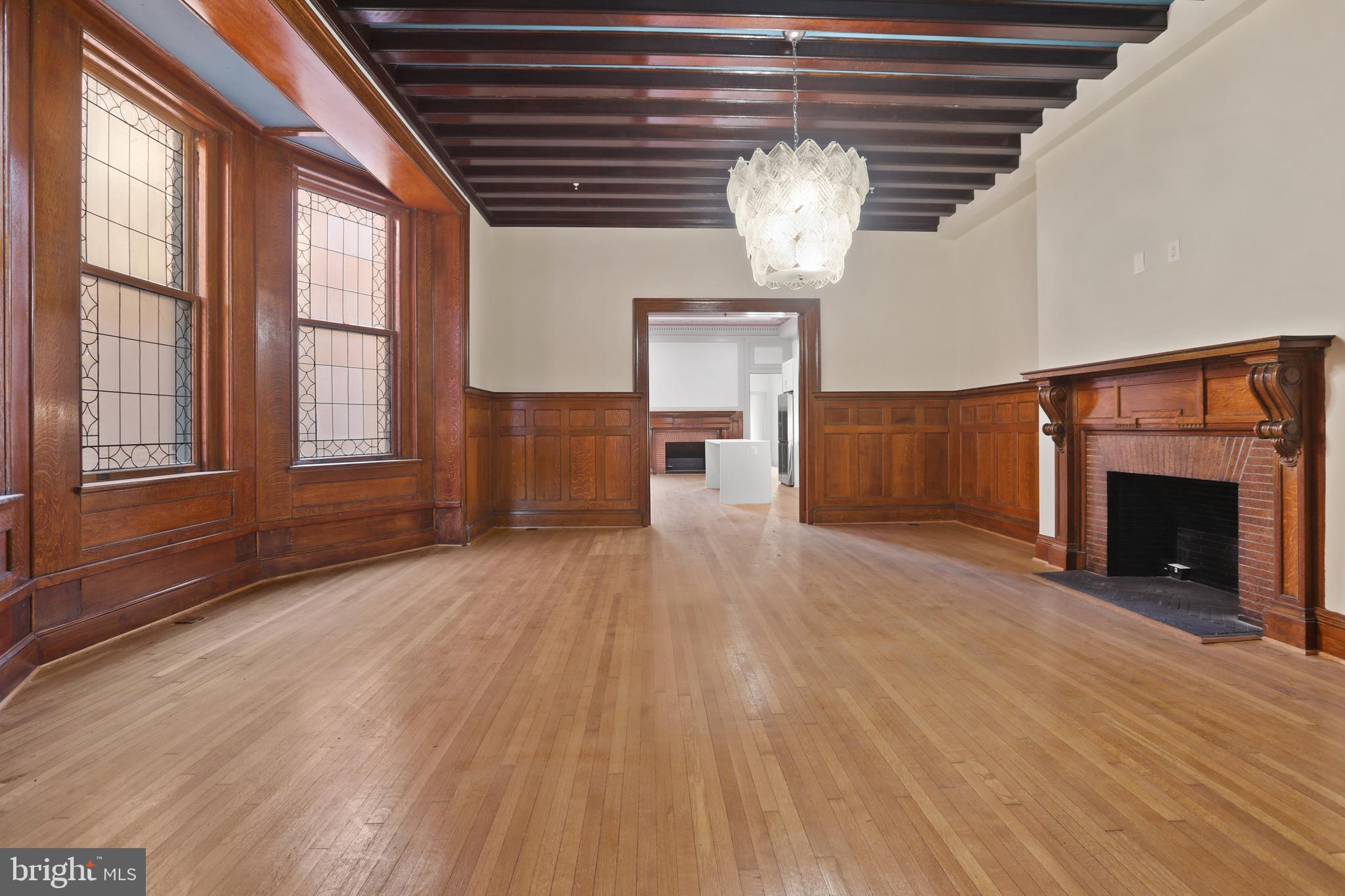 812 Park Avenue, Unit 2FR Baltimore, MD 21201 - Photo 9 of 30 a view of empty room with wooden floor and fireplace