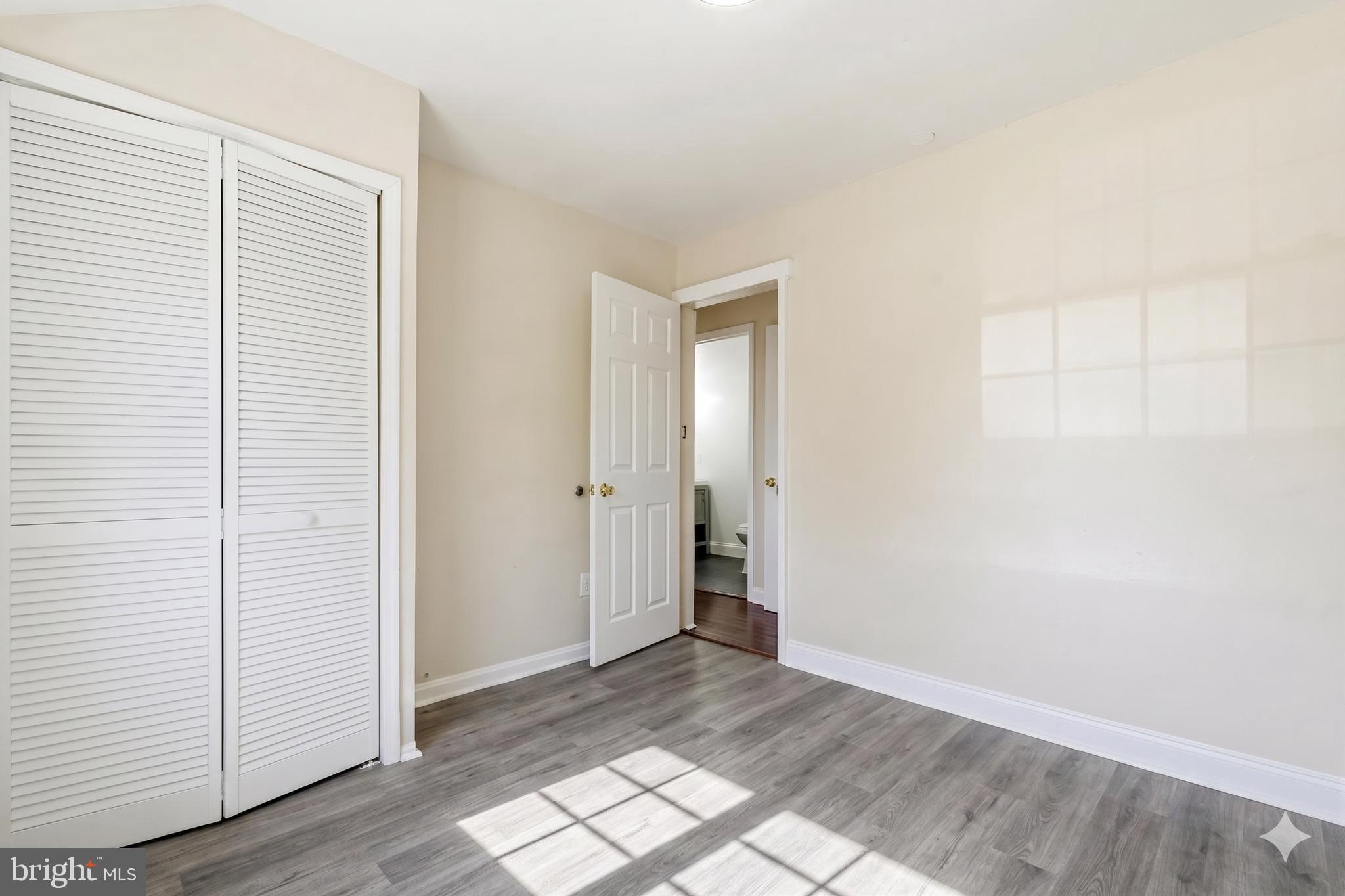 7204 East Inwood Street Landover, MD 20785 - Photo 17 of 24 an empty room with wooden floor and windows