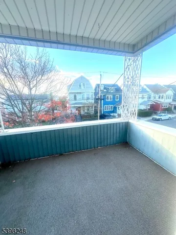 a view of a hallway with wooden shelves