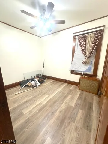 a view of room with wooden floor and fan