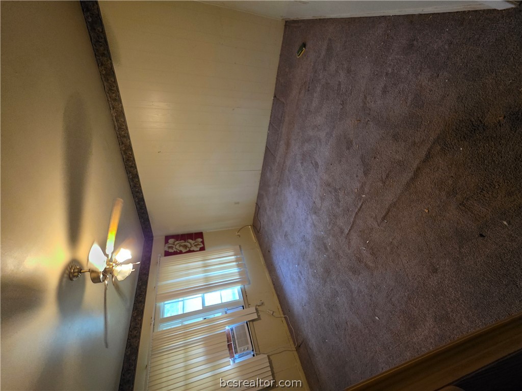3815 Luza Lane Bryan, TX 77807 - Photo 6 of 18 en empty room with windows and ceiling fan