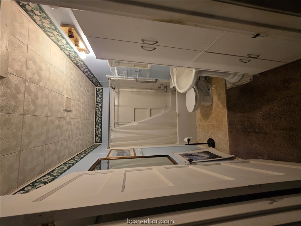 3815 Luza Lane Bryan, TX 77807 - Photo 7 of 18 a bathroom with a granite countertop sink toilet and shower