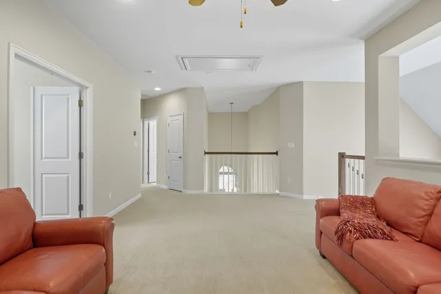 a living room with furniture a refrigerator and a couch