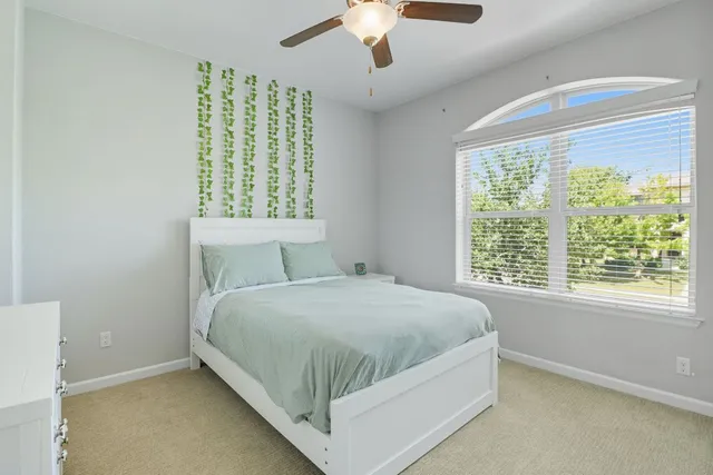 a bed sitting in a bedroom next to a window