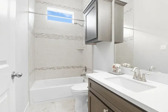 a bathroom with a sink a toilet and bathtub