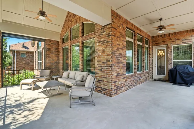 a balcony with furniture and a potted plant