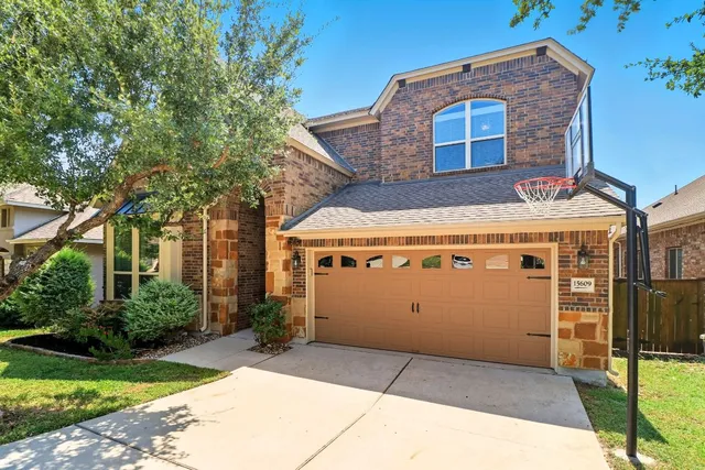 a front view of a building with a garden