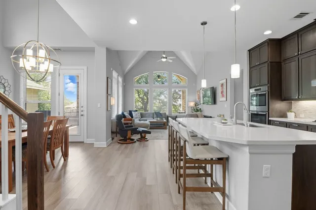 a large kitchen with a table and chairs