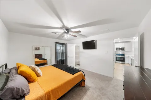 a bedroom with a large bed and a flat screen tv