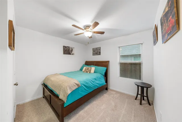 a bedroom with a bed and a chair