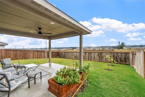 a view of a patio with a table chairs and a yard