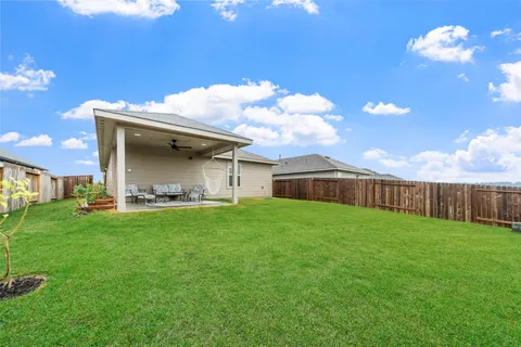 a backyard of a house with table and chairs