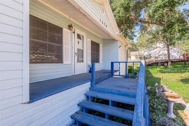 a view of empty room with wooden floor and fireplace
