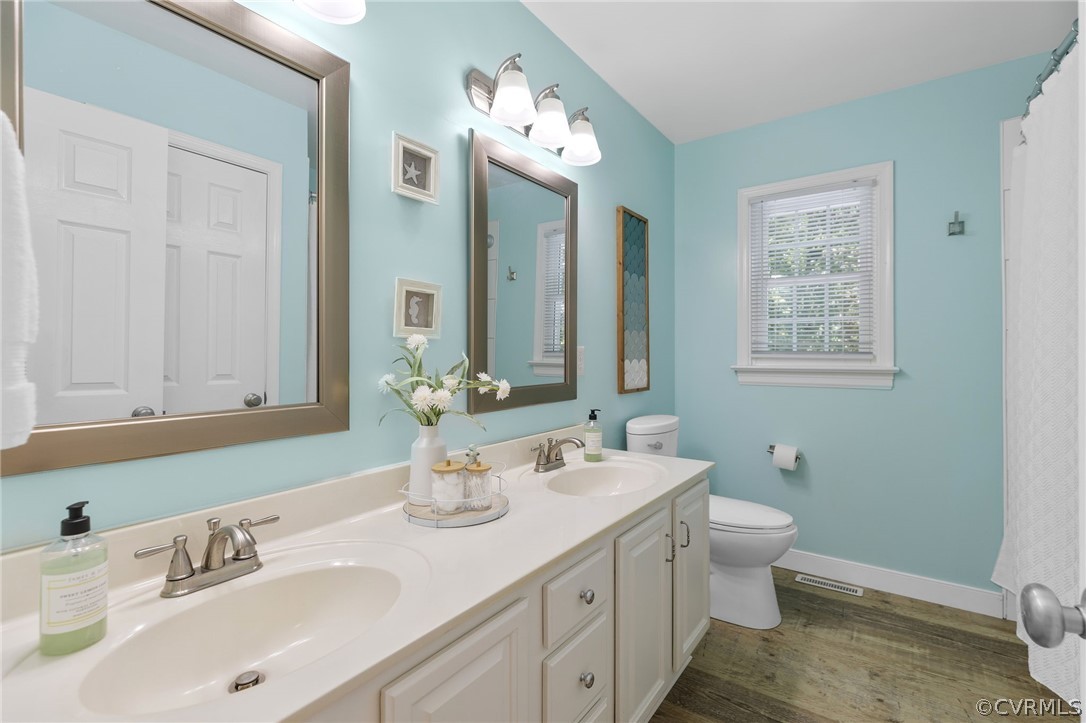 5423 Houndmaster Road Midlothian, VA 23112 - Photo 21 of 49 a bathroom with a double vanity sink toilet and mirror