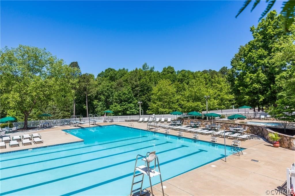 5423 Houndmaster Road Midlothian, VA 23112 - Photo 45 of 49 a view of a swimming pool with an outdoor space and seating area