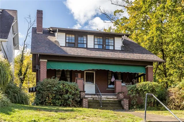 a view of a house with swimming pool and chairs