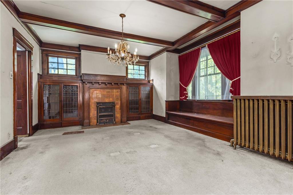 1050 Hiland Avenue Coraopolis, PA 15108 - Photo 12 of 33 a view of an empty room with a fireplace and a window