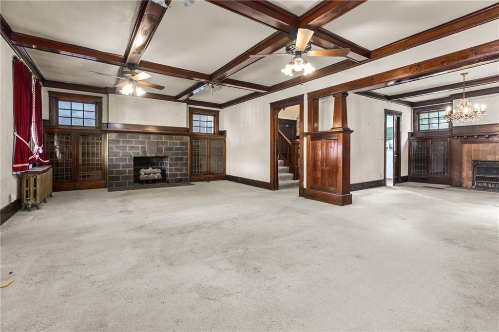 1050 Hiland Avenue Coraopolis, PA 15108 - Photo 5 of 33 a view of an empty room with fireplace and a chandelier