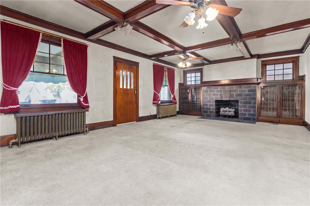 1050 Hiland Avenue Coraopolis, PA 15108 - Photo 6 of 33 a view of an empty room with fireplace and windows