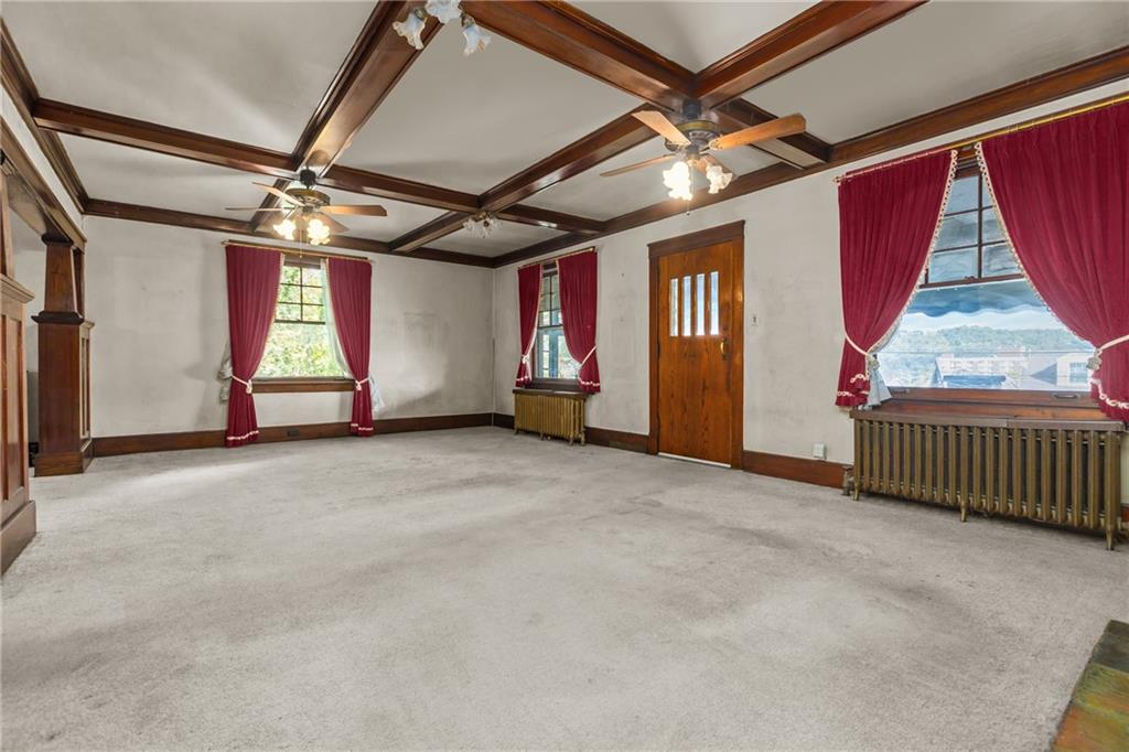 1050 Hiland Avenue Coraopolis, PA 15108 - Photo 10 of 33 a view of an empty room with wooden floor and windows