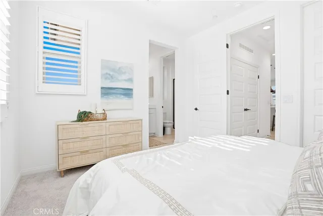 a bathroom with a sink a mirror and a potted plant