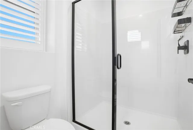 a bedroom with a bed and painting on the wall