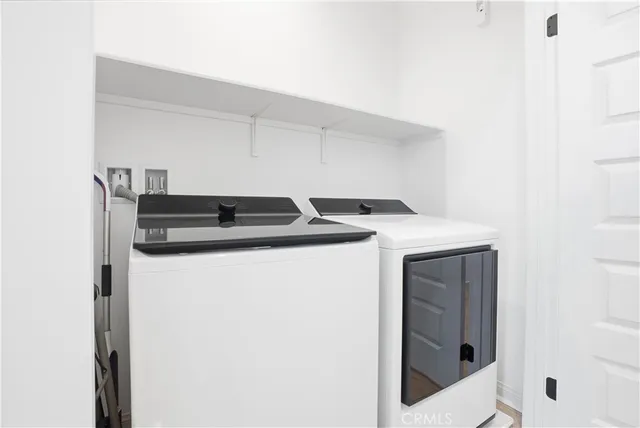 a view of a street with an house and trees in the background