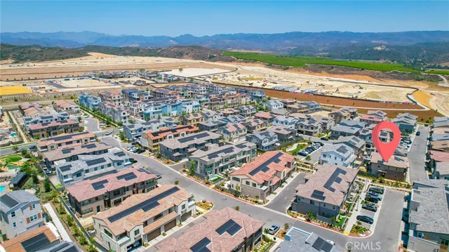 an aerial view of a swimming pool with outdoor seating and yard