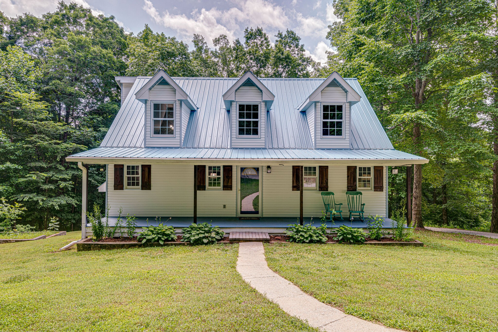 1803 East Piney Road Dickson, TN 37055 - Photo 1 of 46 a front view of a house with a yard table and chairs
