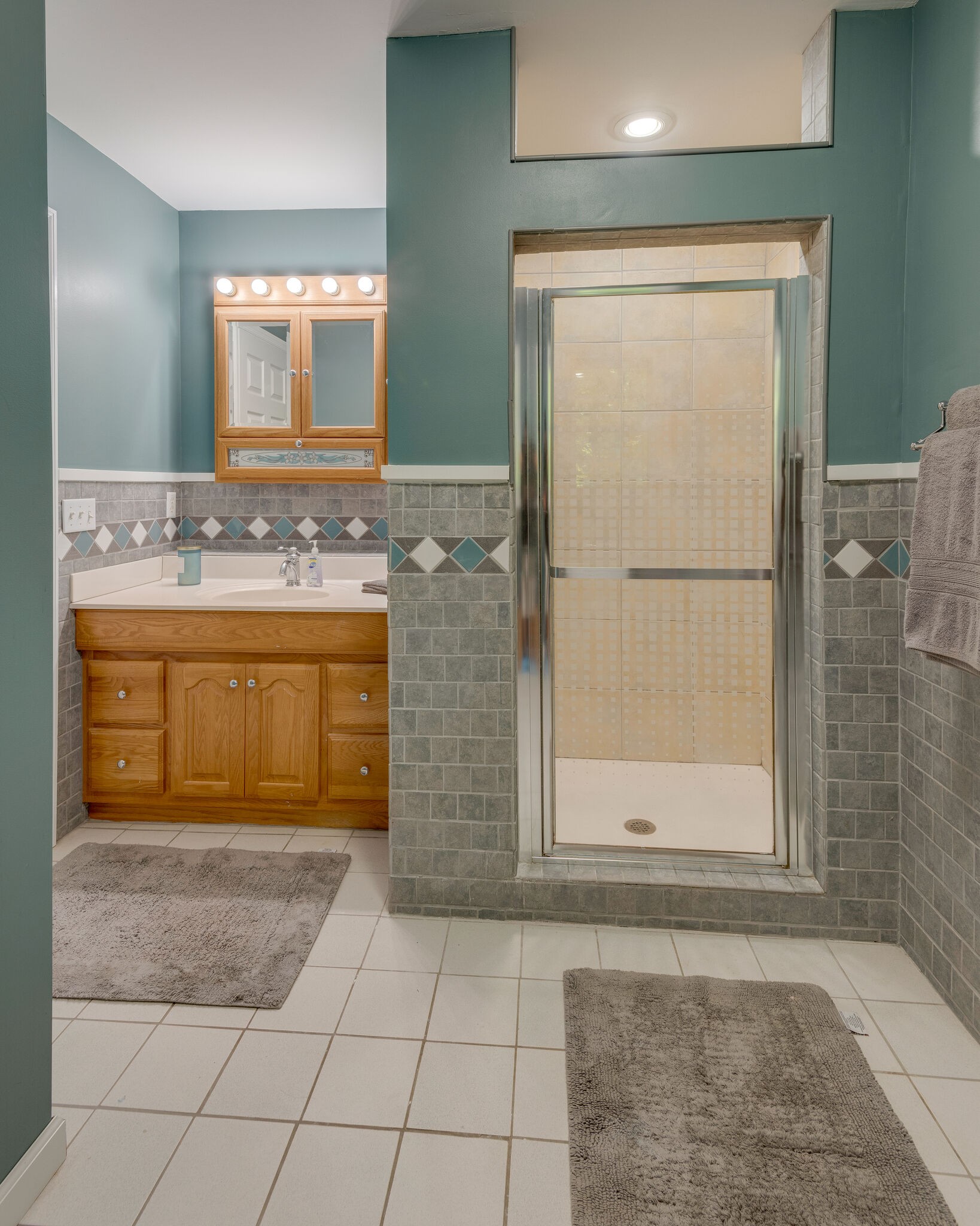 1803 East Piney Road Dickson, TN 37055 - Photo 22 of 46 a bathroom with a granite countertop sink a mirror and a shower