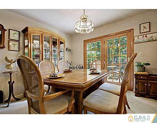 8 June Way Middlesex, NJ 08846 - Photo 12 of 25 a view of a dining room with furniture a chandelier and wooden floor