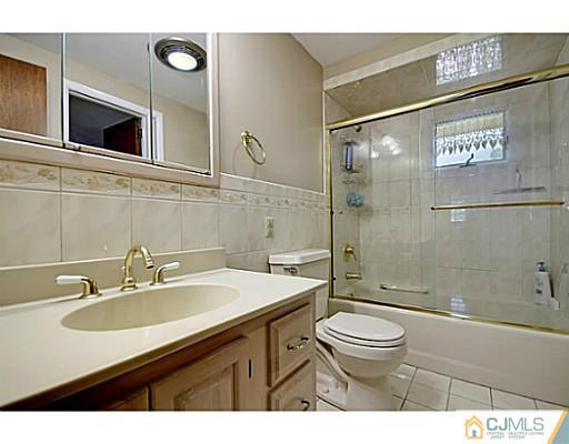 8 June Way Middlesex, NJ 08846 - Photo 14 of 25 a bathroom with a sink a toilet and shower