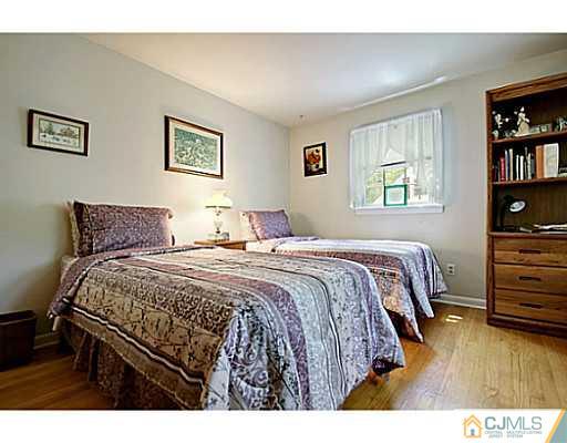 8 June Way Middlesex, NJ 08846 - Photo 15 of 25 a bedroom with a bed a dresser and book shelf